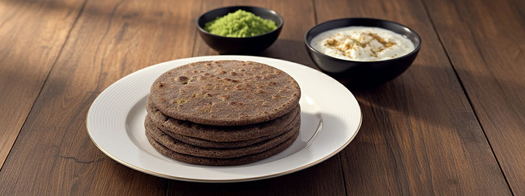 Rustic Mandua ki Roti made from finger millet flour, served hot with ghee and jaggery — a nutritious staple of Uttarakhand mountain diet.